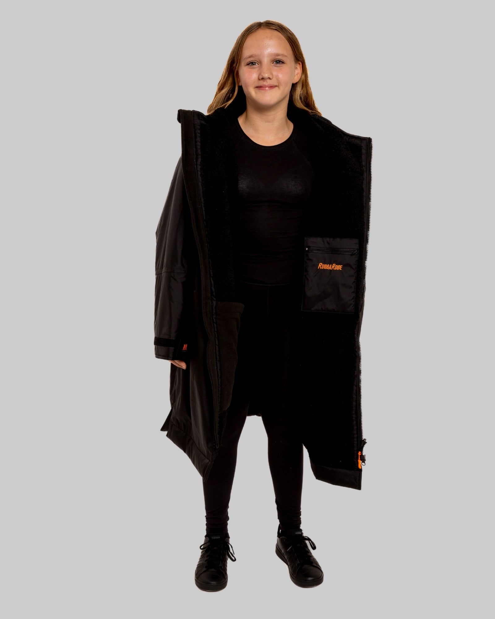 Model wearing RuggaRobe black change robe with black fleece interior on grey background