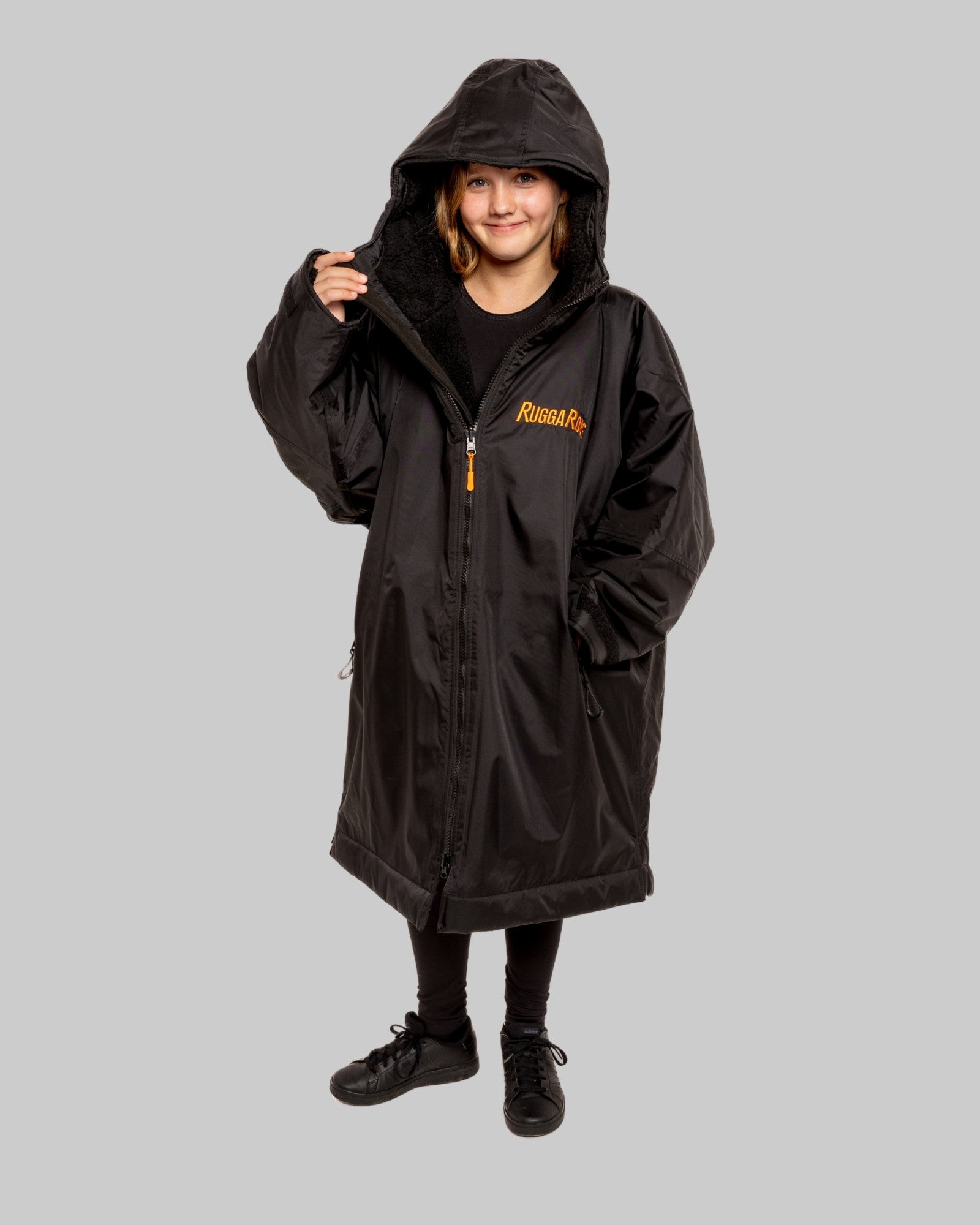 Model wearing RuggaRobe black change robe with black fleece interior on grey background