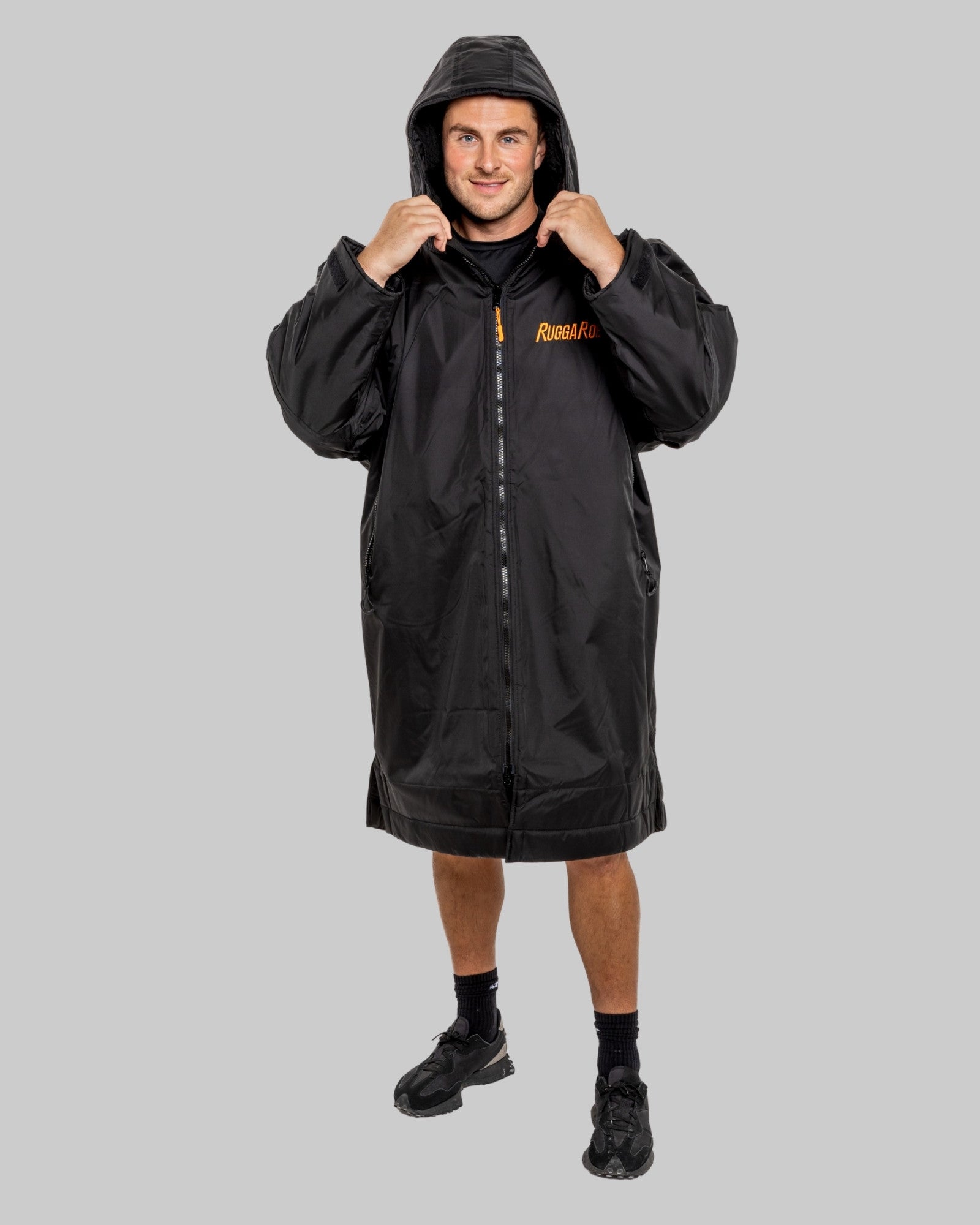 Person wearing a black ruggarobe with black interior on a grey background