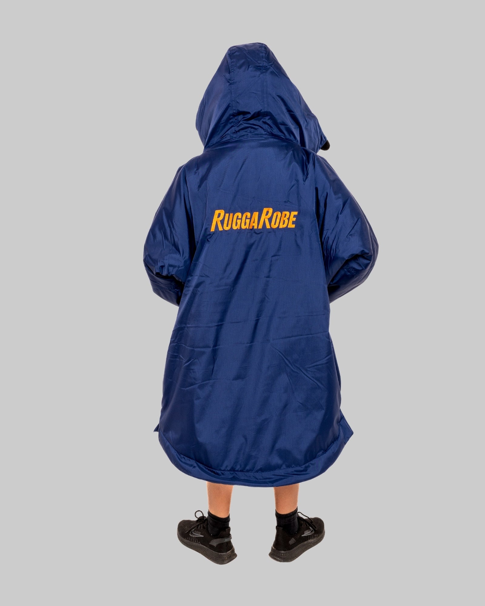 Child wearing a blue Rugga Robe on a grey background