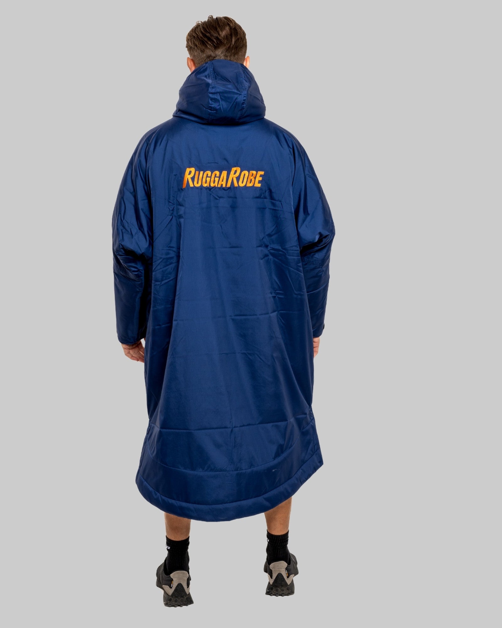 Person wearing a blue Rugga Robe on a gray background