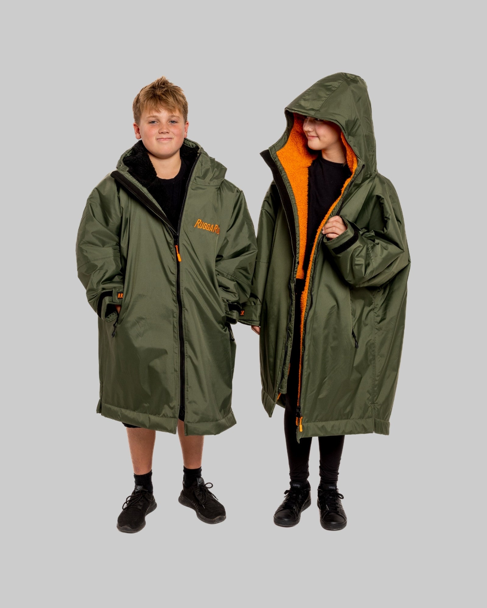 Two people wearing green hooded ruggarobes, with 'RuggaRobe' branding.
