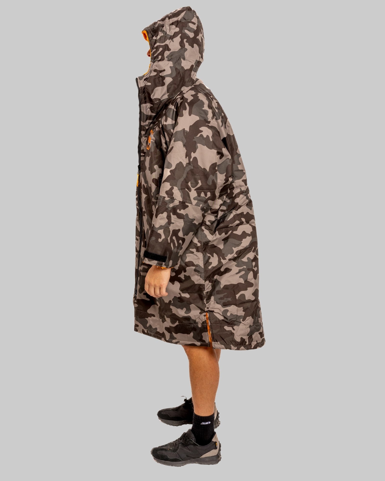 Model wearing RuggaRobe grey camo change robe with orange fleece interior on grey background