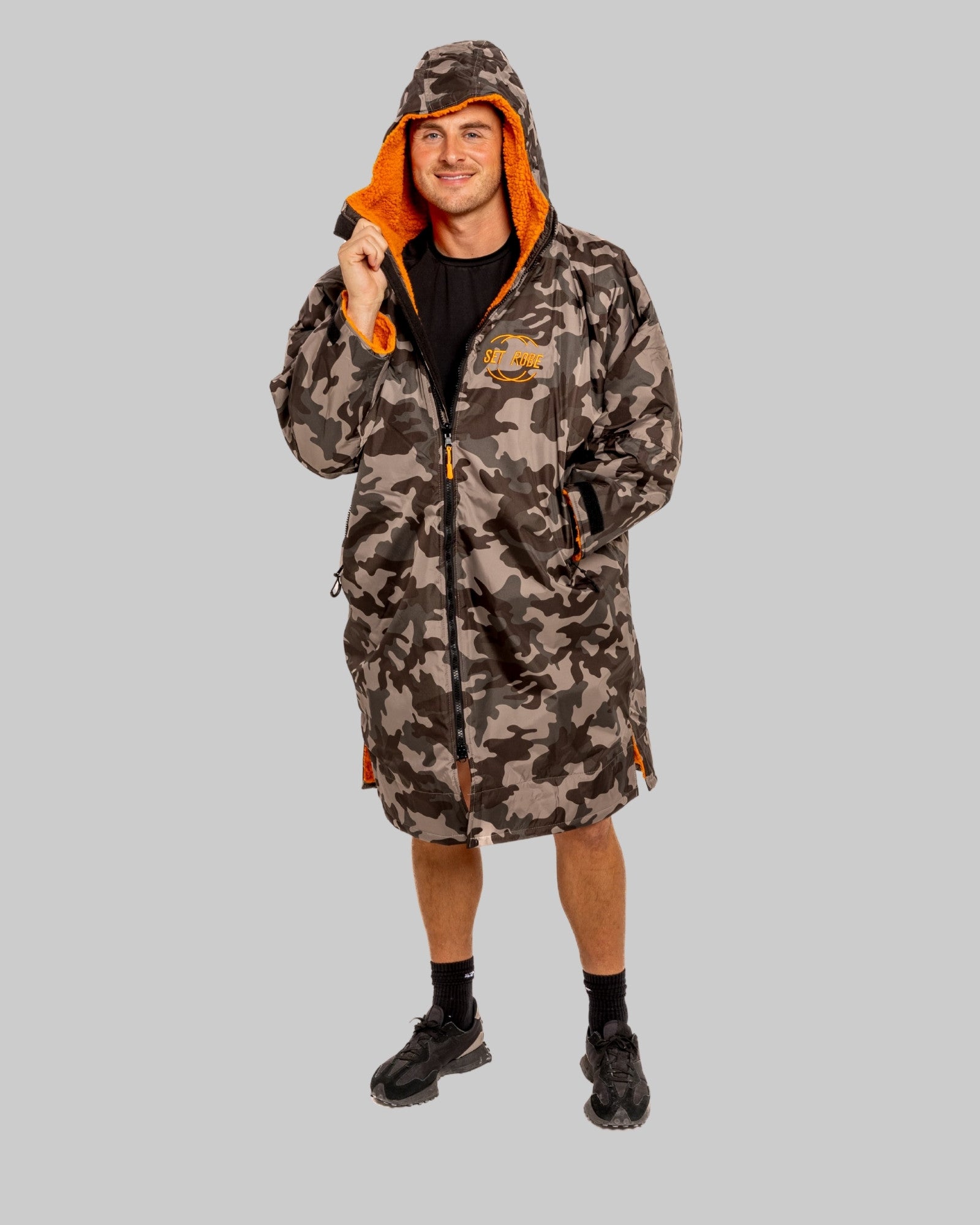 Model wearing RuggaRobe grey camo change robe with orange fleece interior on grey background