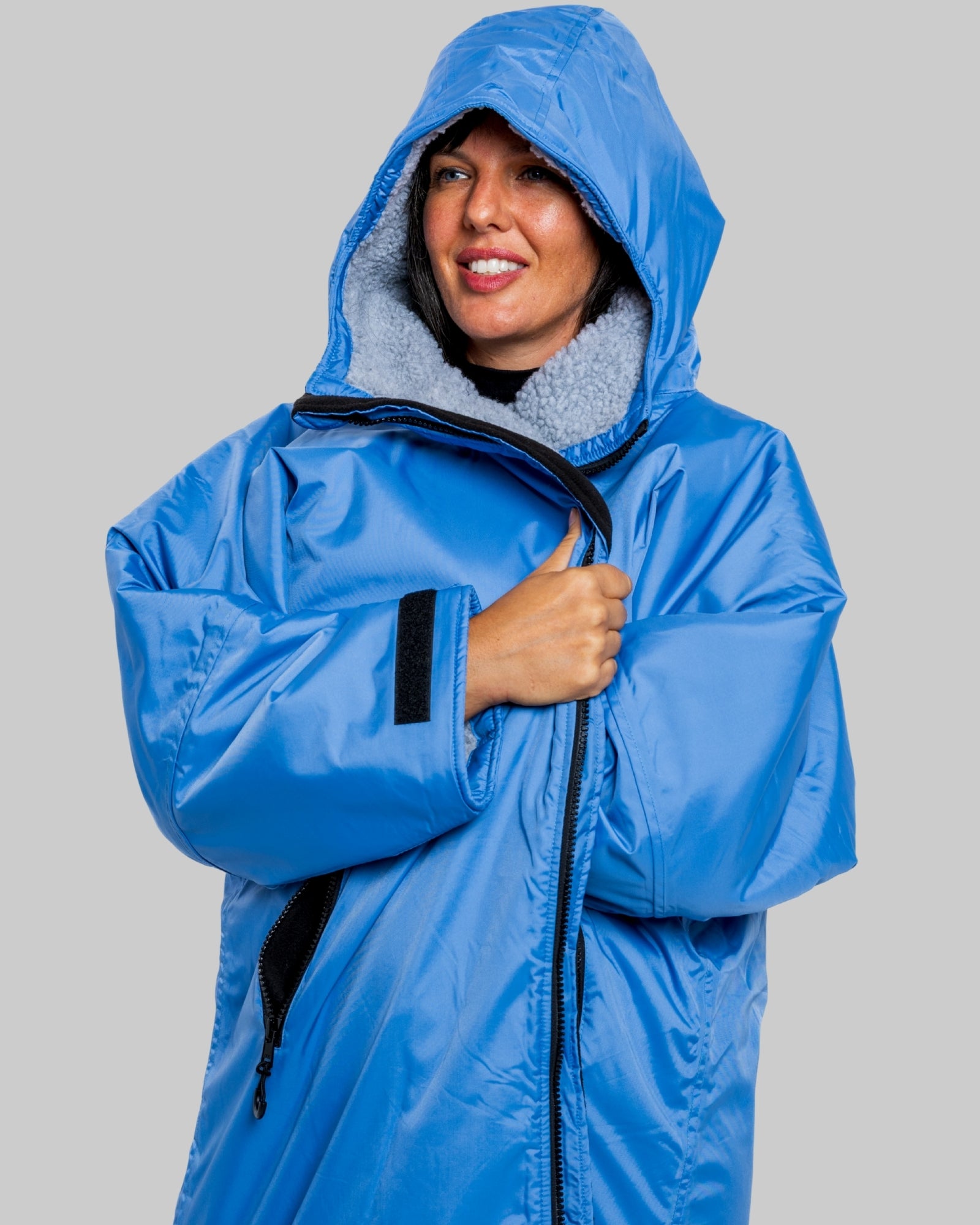 Model wearing a pale blue with grey feece ruggarobe on a gray background