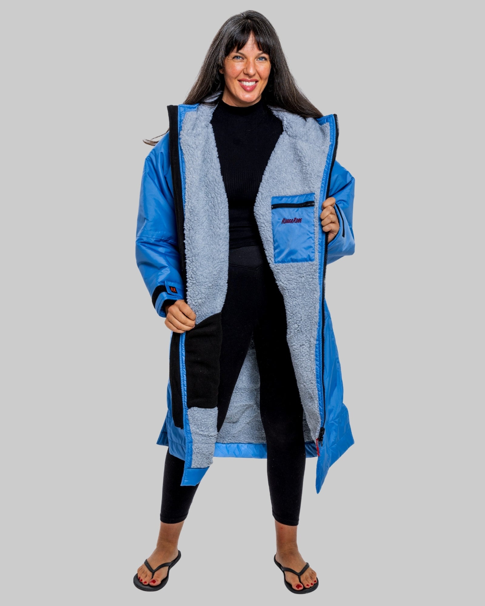 Model wearing a pale blue with grey feece ruggarobe on a gray background