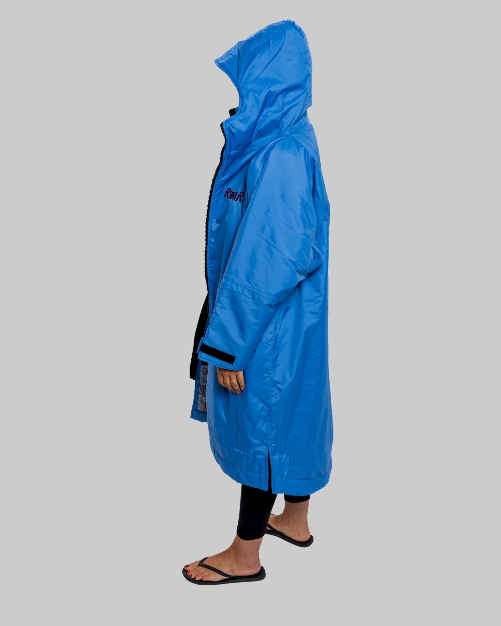 Model wearing a pale blue with grey feece ruggarobe on a gray background