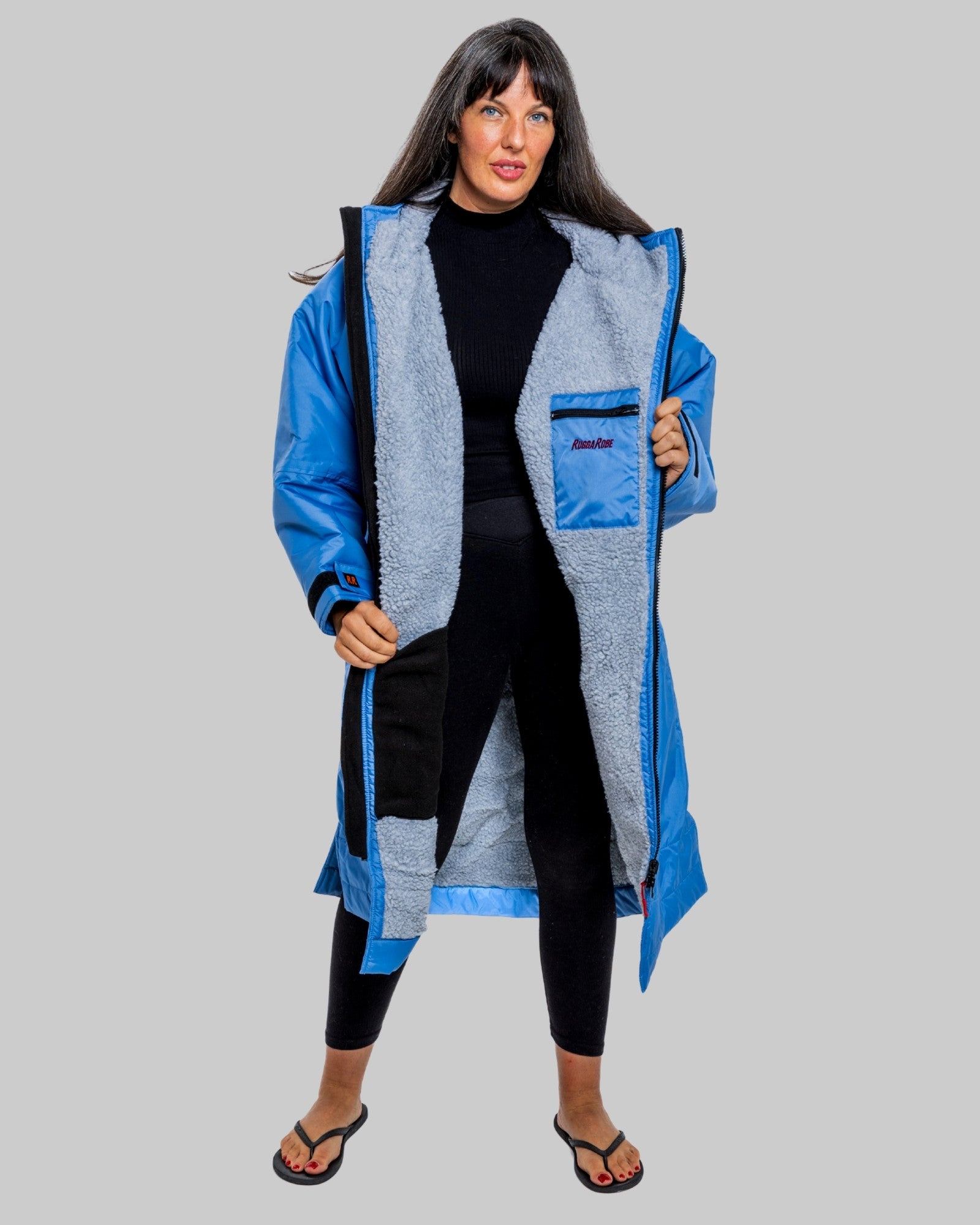 Model wearing a pale blue with grey feece ruggarobe on a gray background