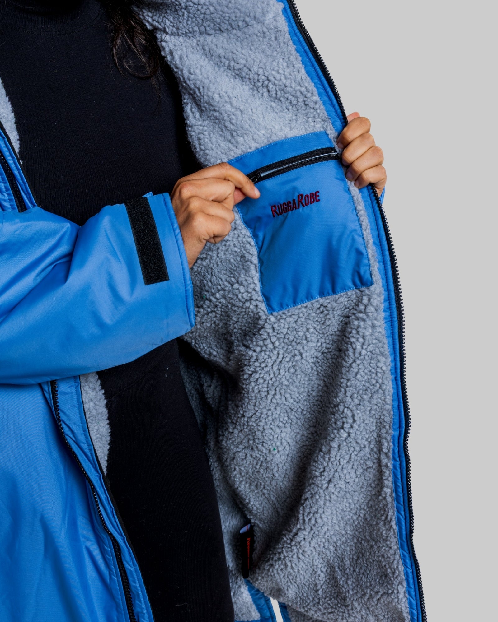 Blue and gray jacket with a brand logo on a gray background