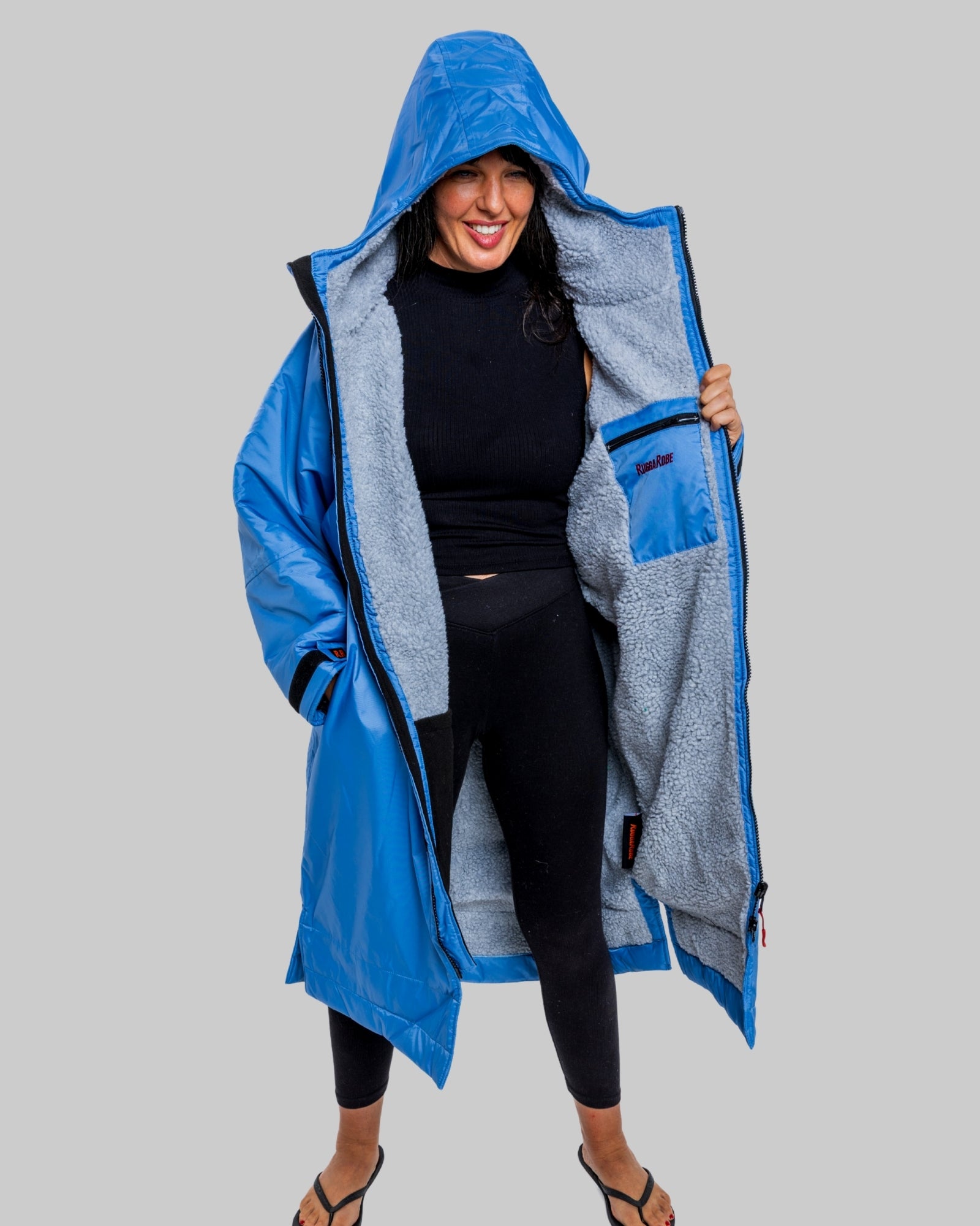 Model wearing a pale blue with grey fleece ruggarobe on a gray background
