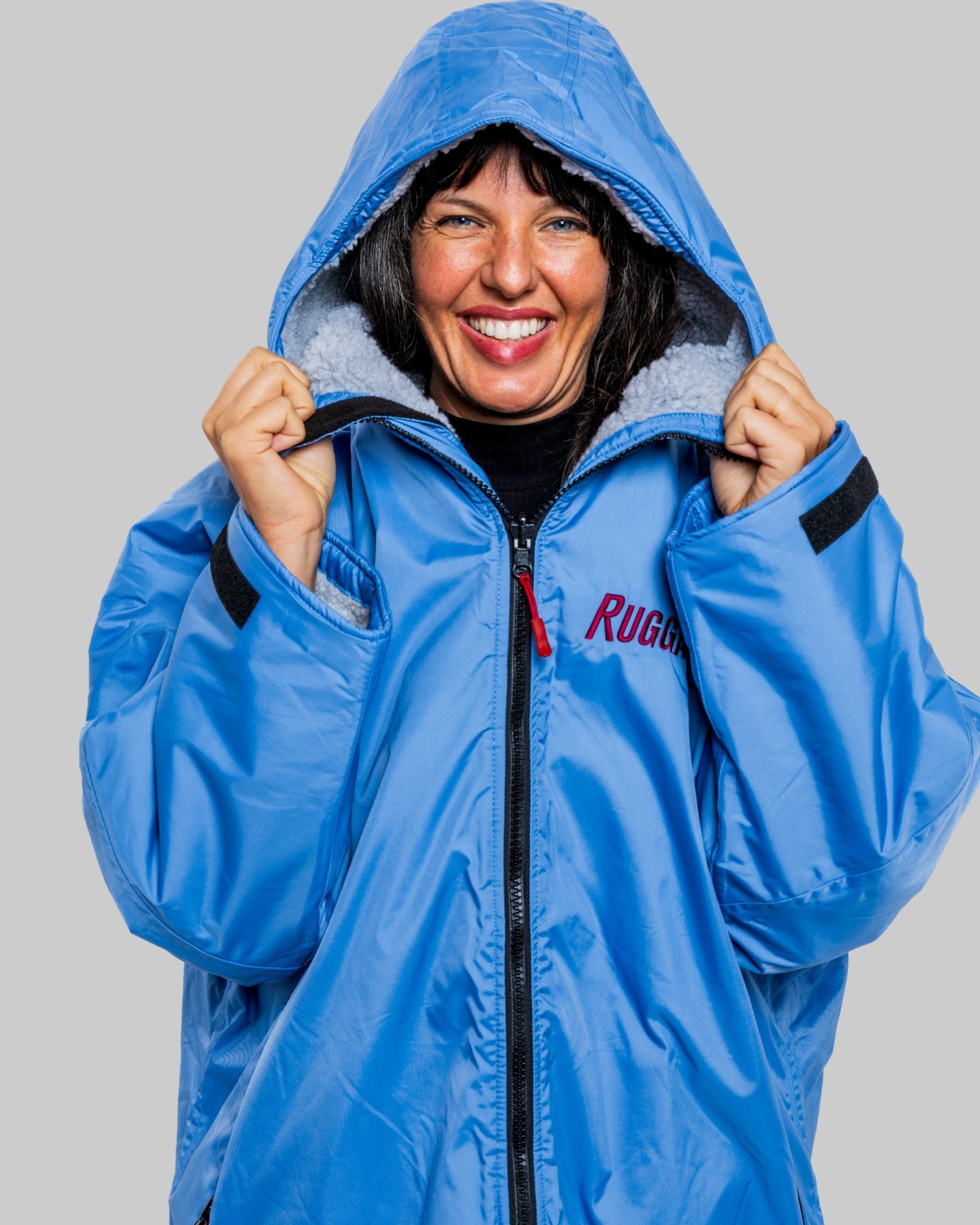 Model wearing a pale blue with grey feece ruggarobe on a gray background