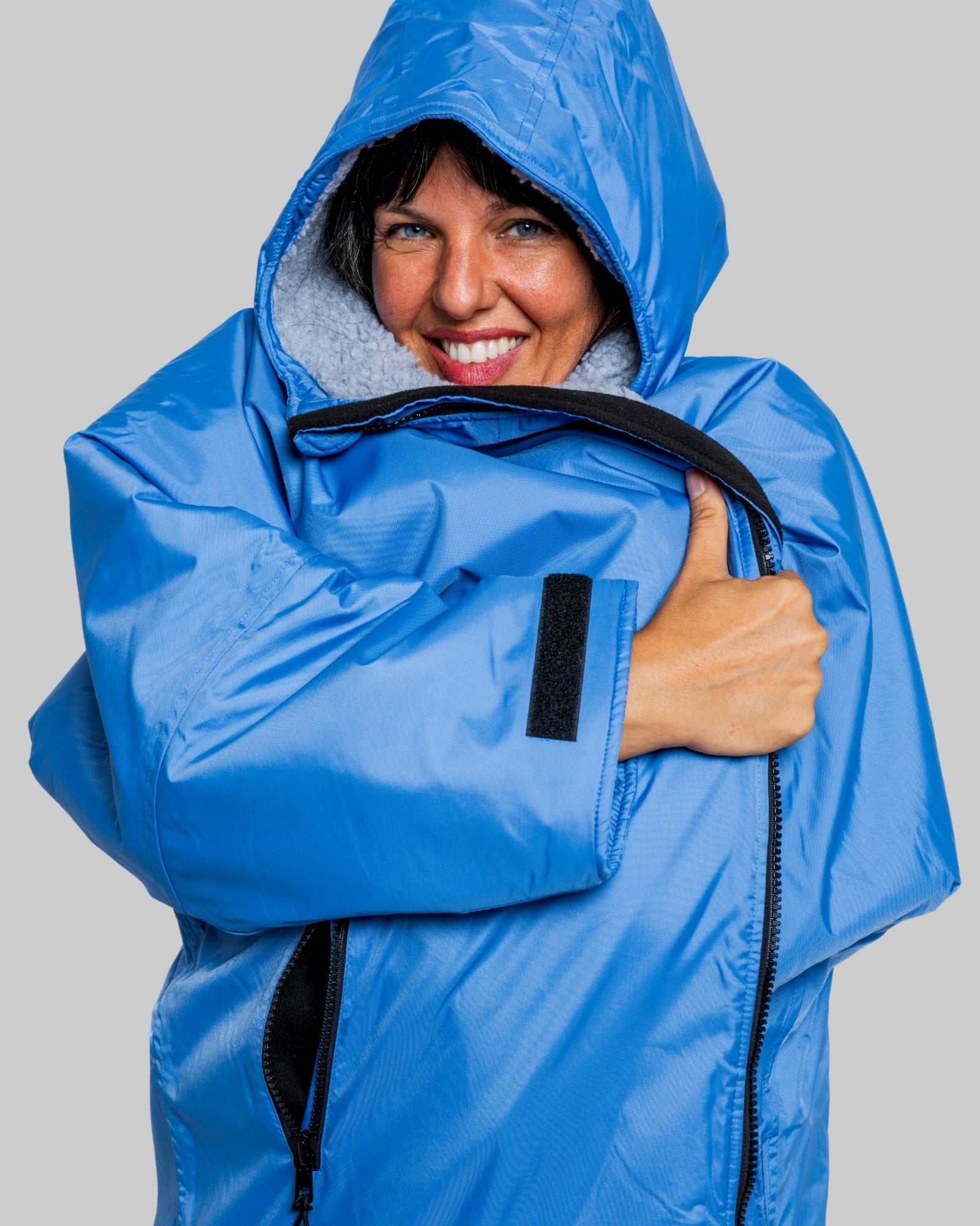 Model wearing a pale blue with grey feece ruggarobe on a gray background