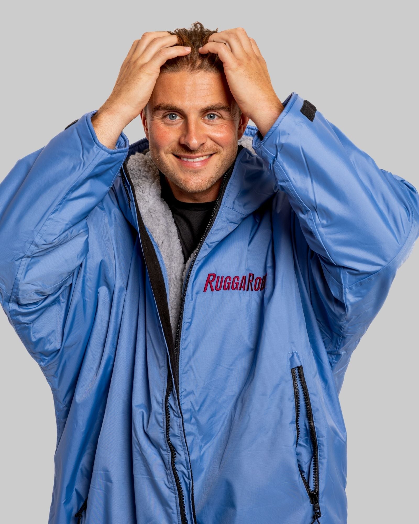 Model wearing a pale blue with grey feece ruggarobe on a gray background