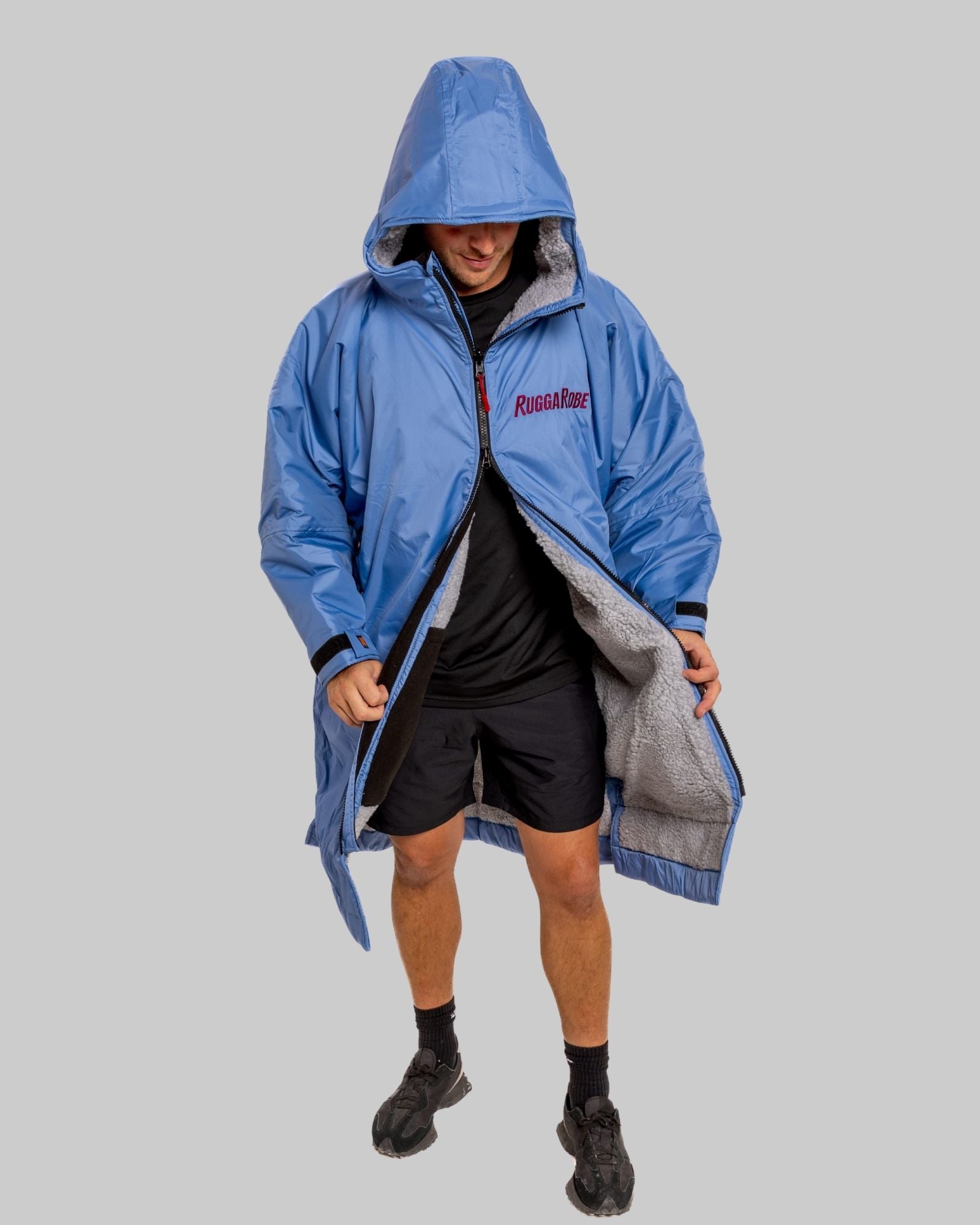Model wearing a pale blue with grey feece ruggarobe on a gray background