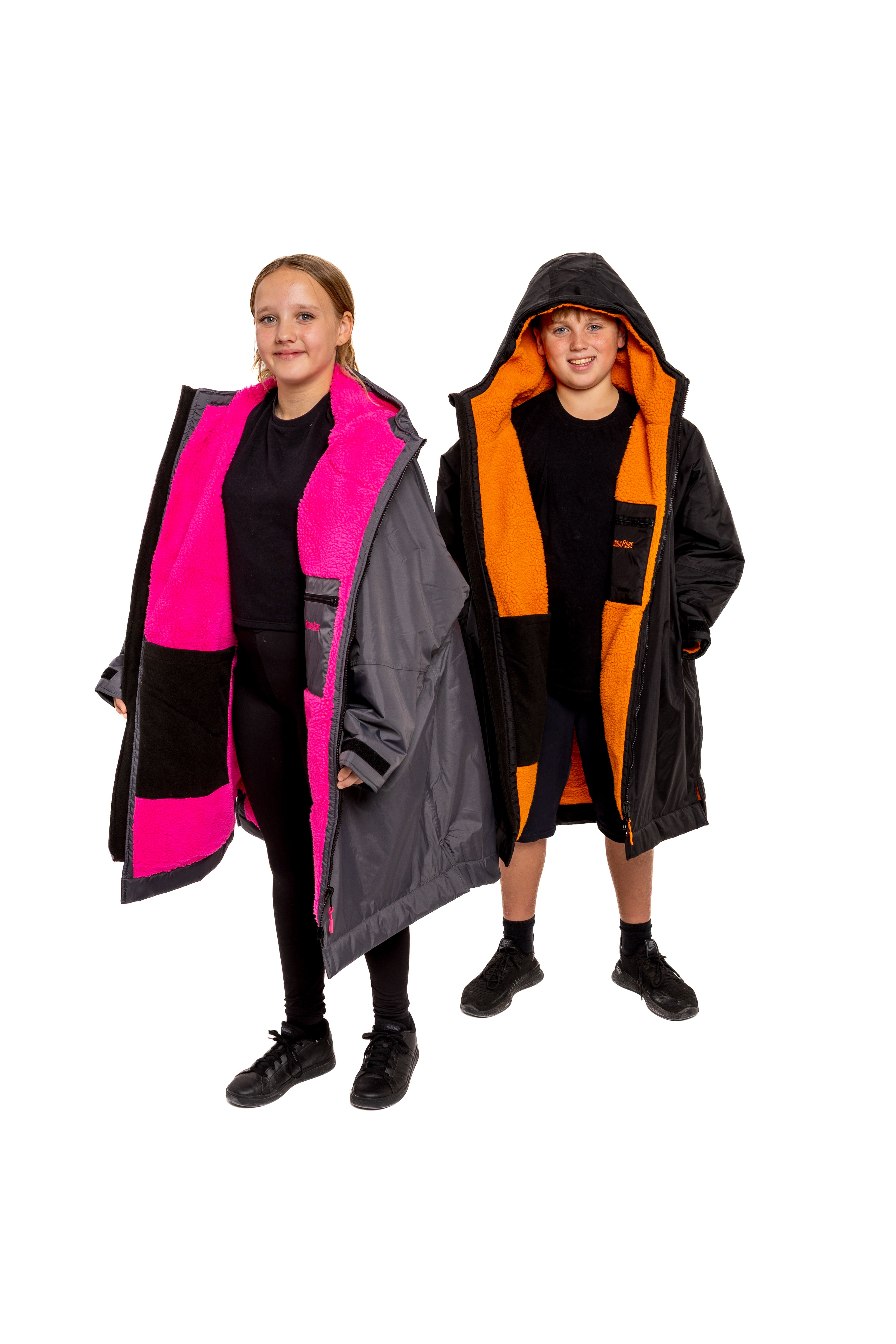 Two people wearing colourful Rugga Robe change robes on a white background