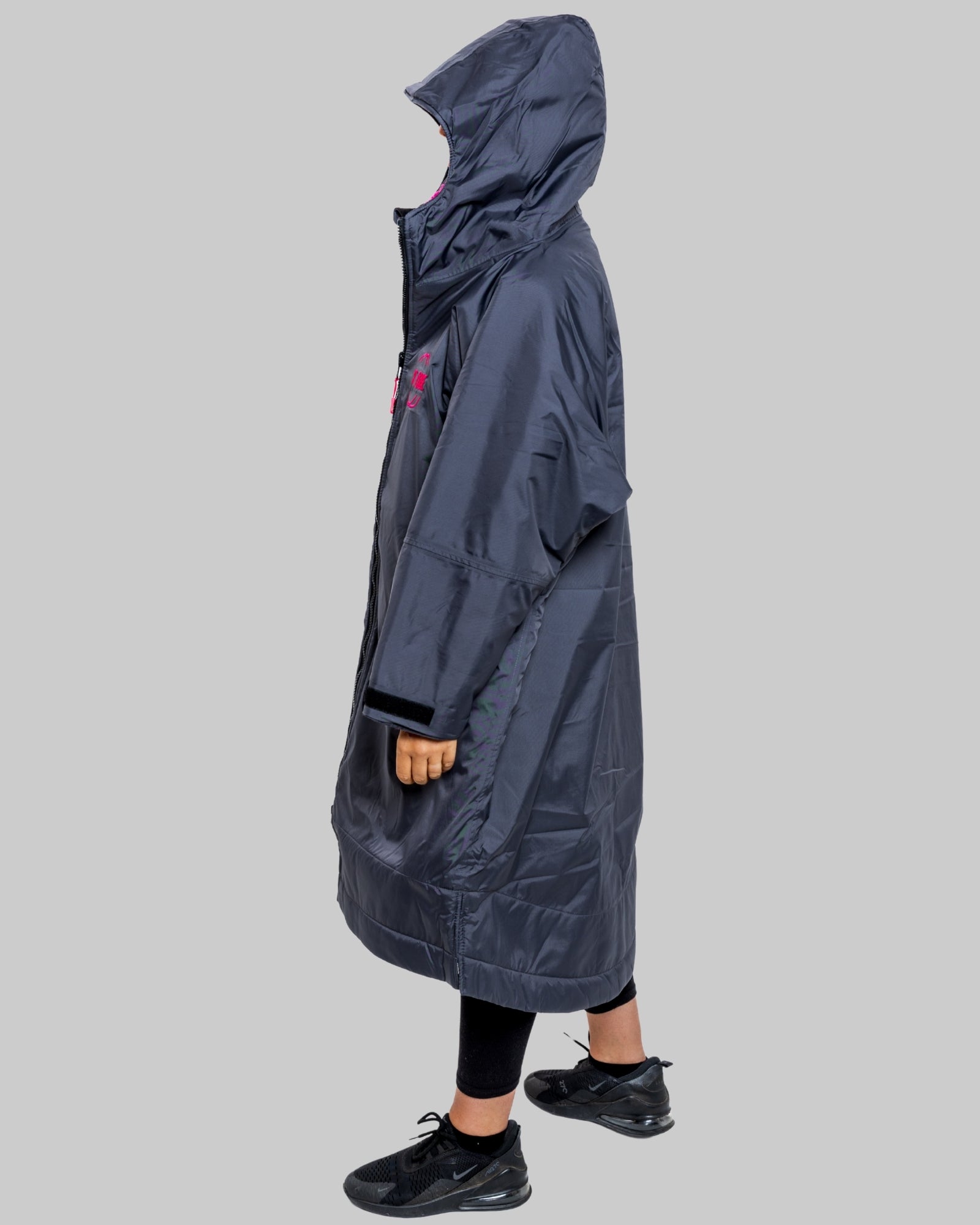 Model wearing RuggaRobe slate grey change robe with pink fleece interior on grey background