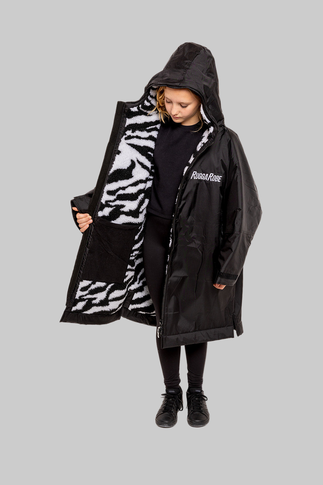 Model wearing RuggaRobe zebra change robe on grey background