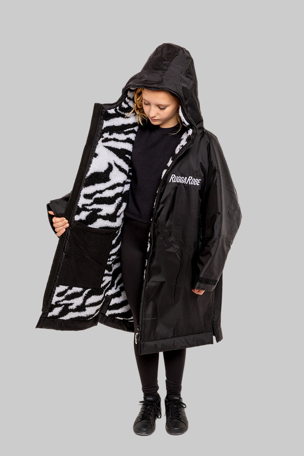 Model wearing RuggaRobe zebra change robe on grey background