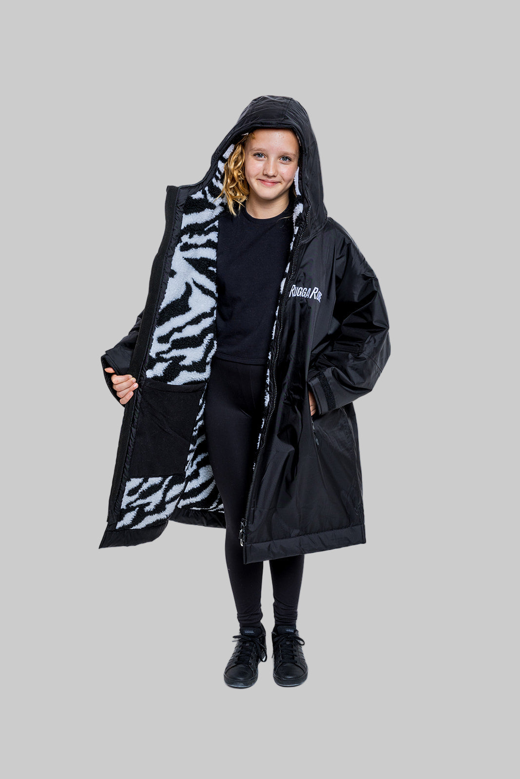Model wearing RuggaRobe zebra change robe on grey background