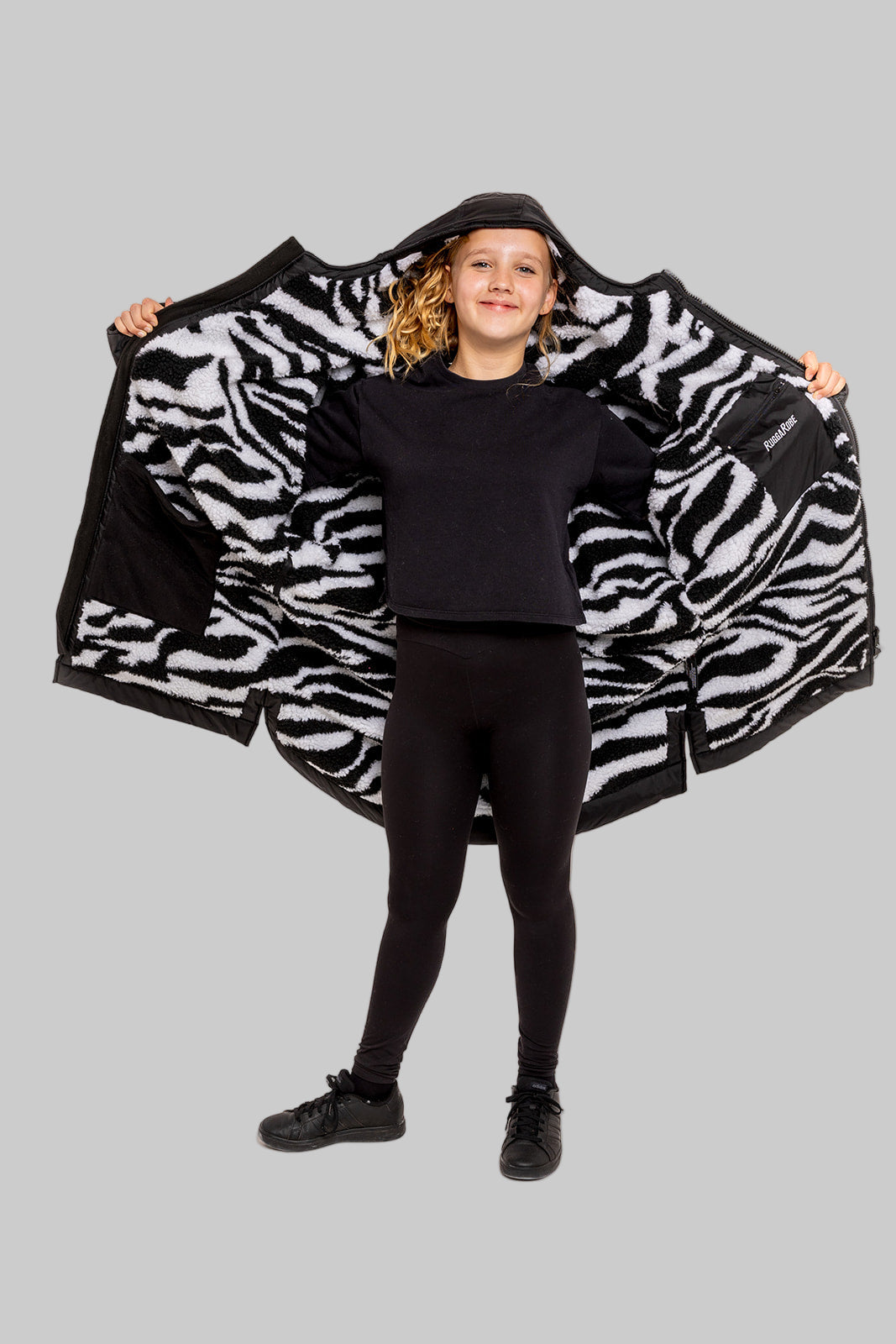 Model wearing RuggaRobe zebra change robe on grey background