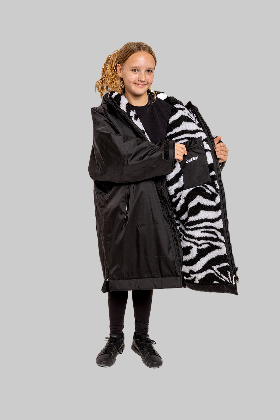 Model wearing RuggaRobe zebra change robe on grey background