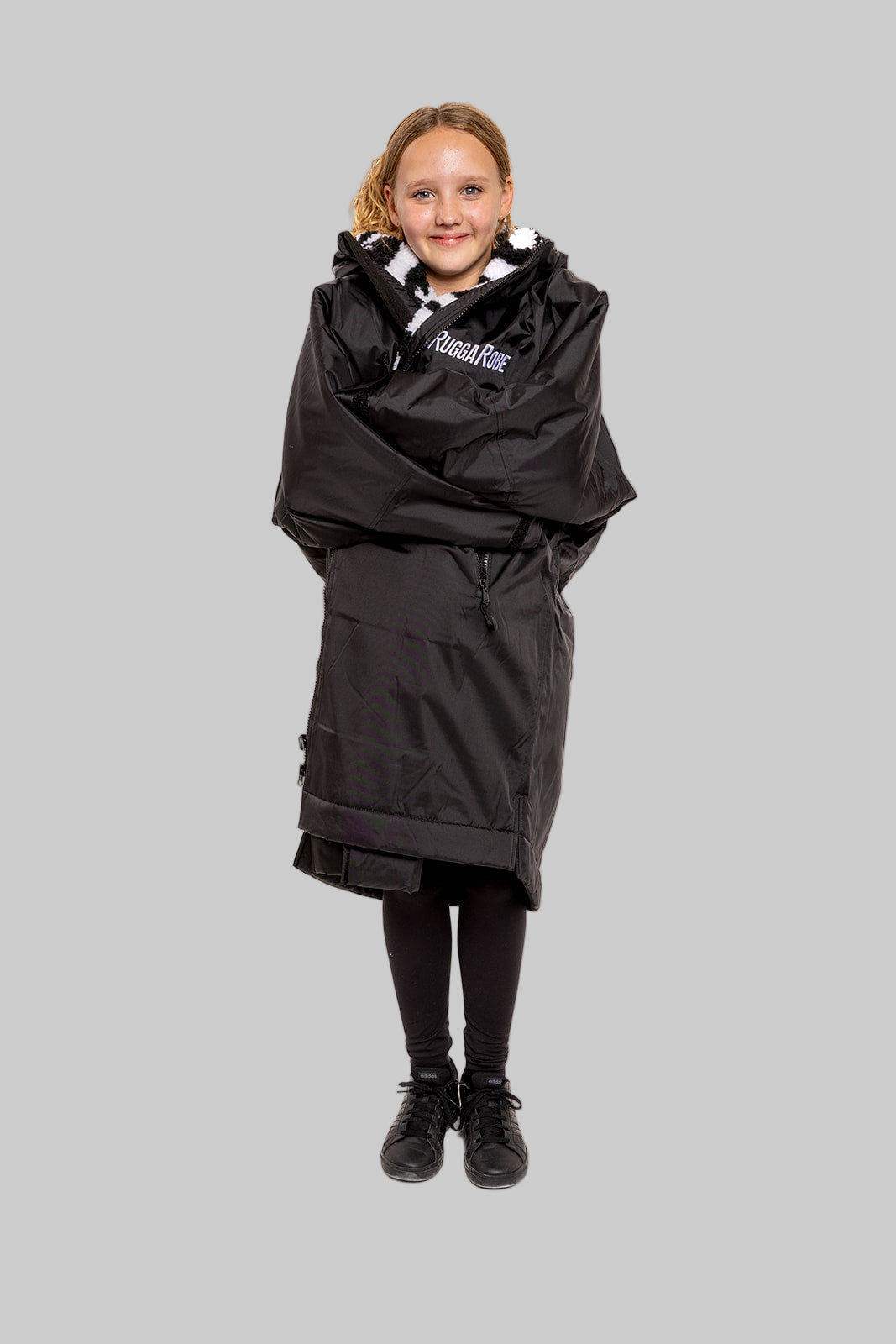 Model wearing RuggaRobe zebra change robe on grey background