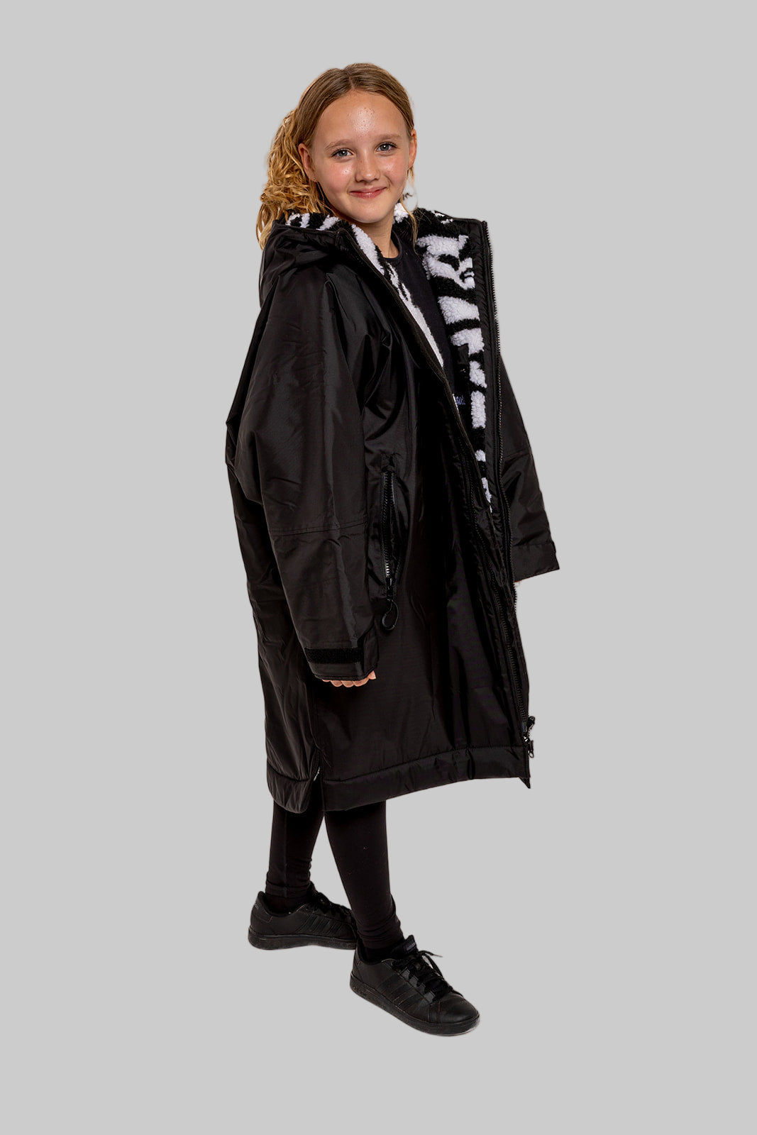 Model wearing RuggaRobe zebra change robe on grey background