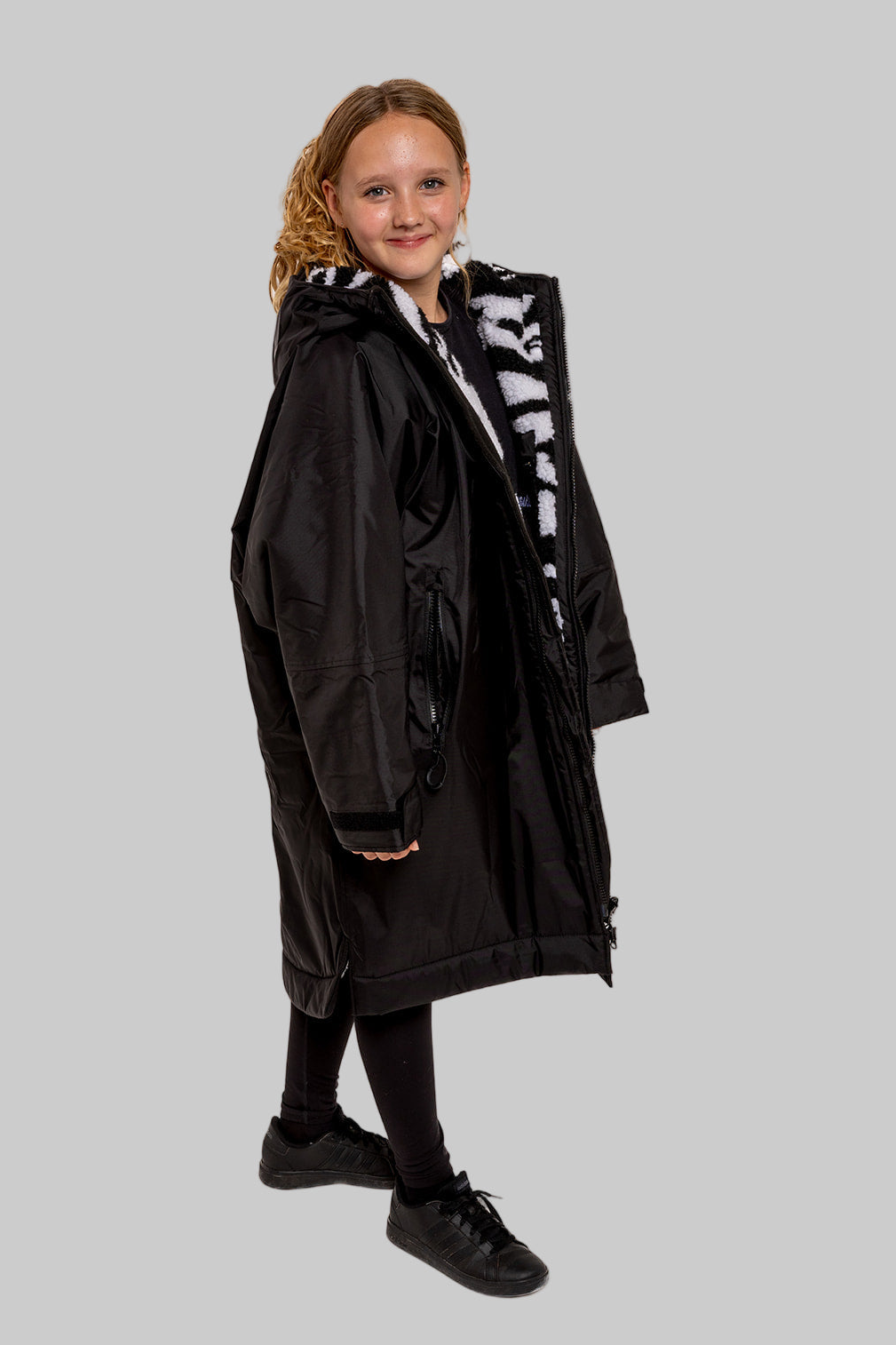 Model wearing RuggaRobe zebra change robe on grey background