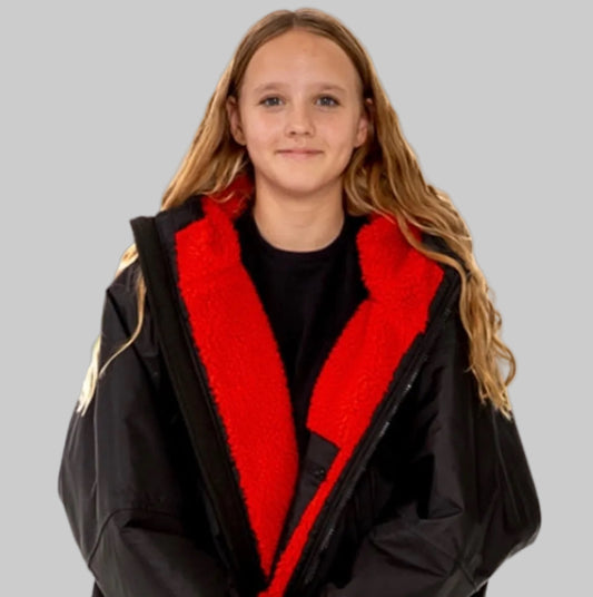 Model wearing RuggaRobe black change robe with red fleece interior on grey background