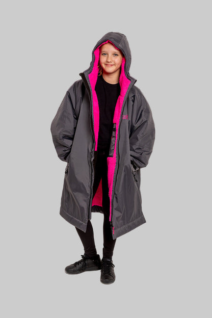 Model wearing RuggaRobe slate grey change robe with pink fleece interior on grey background