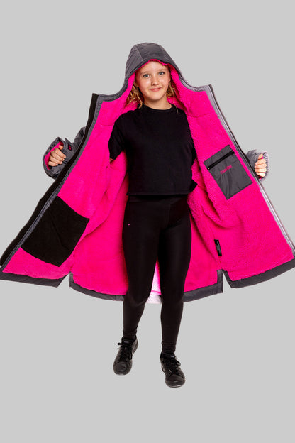 Model wearing RuggaRobe slate grey change robe with pink fleece interior on grey background