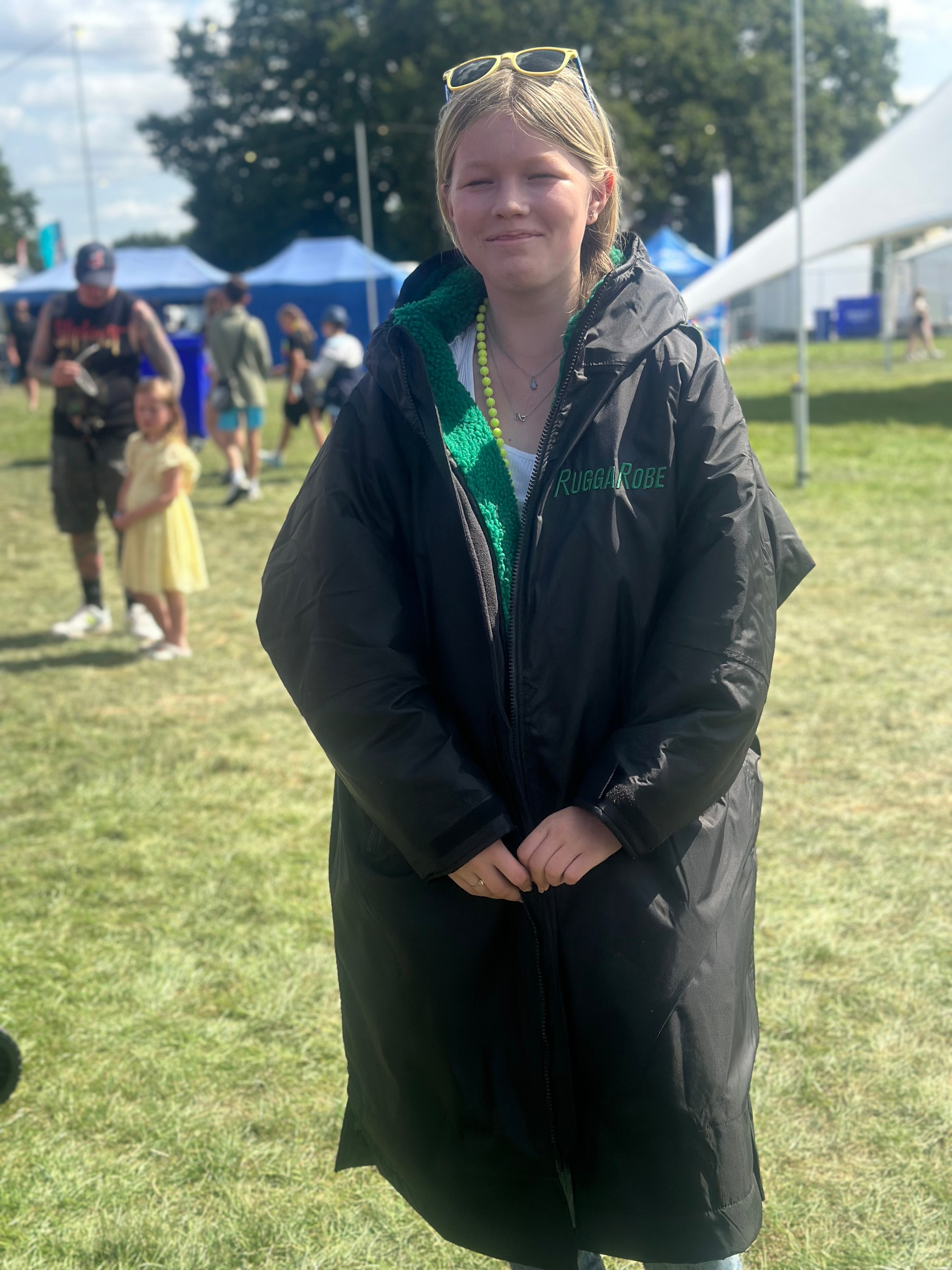 Person wearing a black ruggarobe with visible branding in an outdoor setting