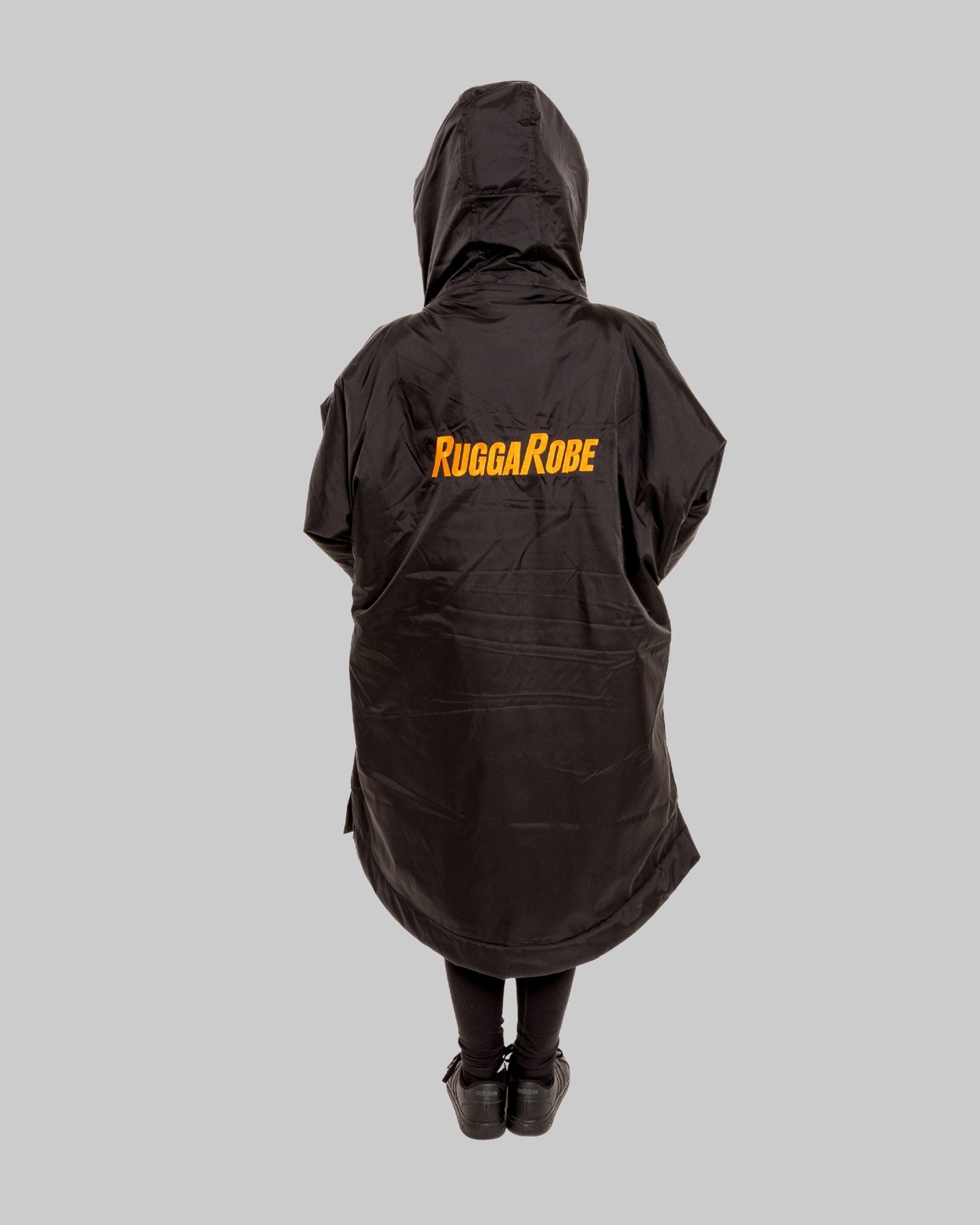 Model wearing RuggaRobe black change robe with black fleece interior on grey background