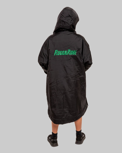 Person wearing a black change robe with 'Rugga Robe' branding on the back against a gray background