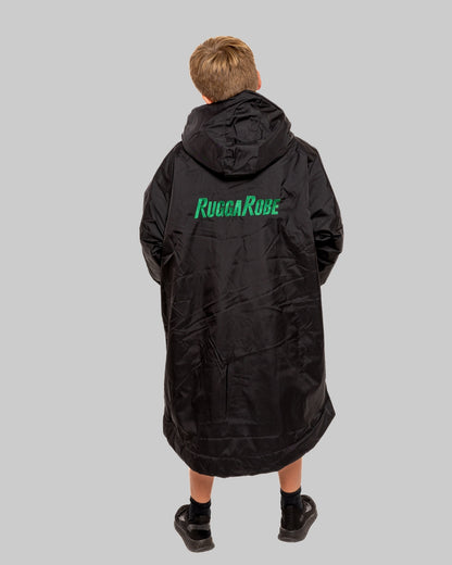 Model wearing RuggaRobe black change robe with green fleece interior on grey background