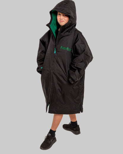 Model wearing RuggaRobe black change robe with green fleece interior on grey background