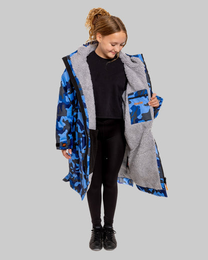 Model wearing RuggaRobe blue camo change robe with grey fleece interior on grey background
