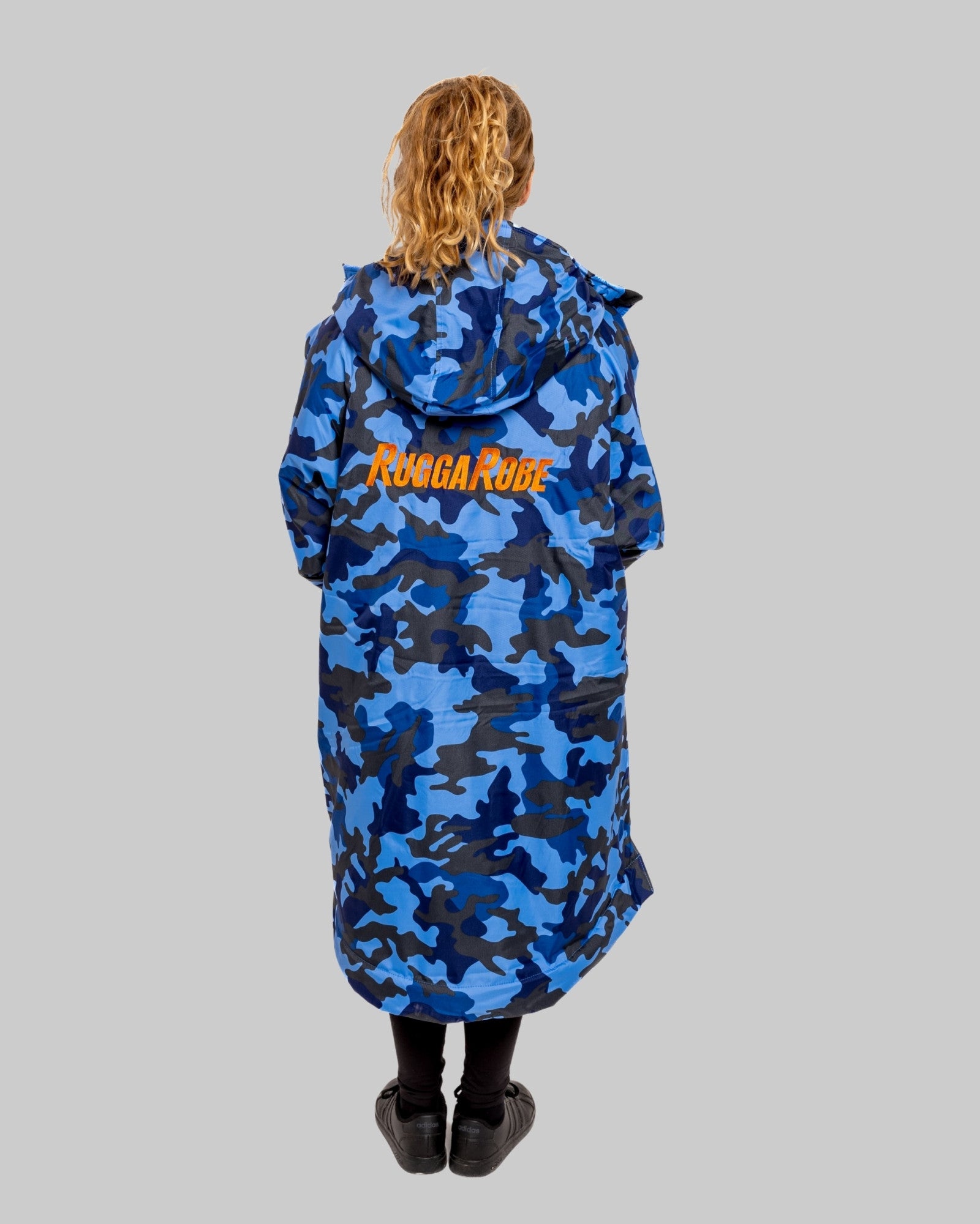 Person wearing a blue camouflage coat with 'RuggaRobe' text on a gray background