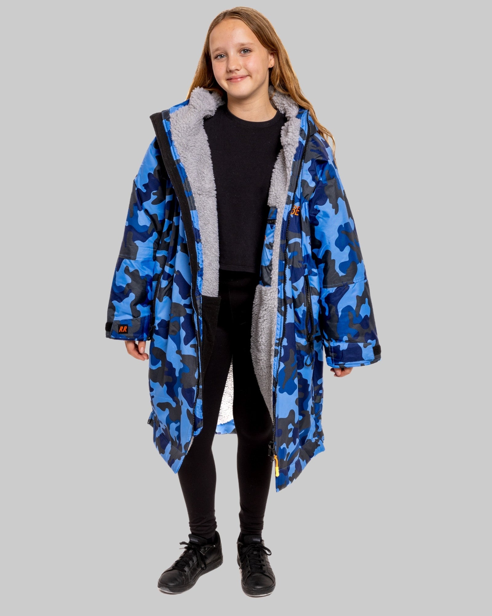 Model wearing RuggaRobe blue camo change robe with grey fleece interior on grey background