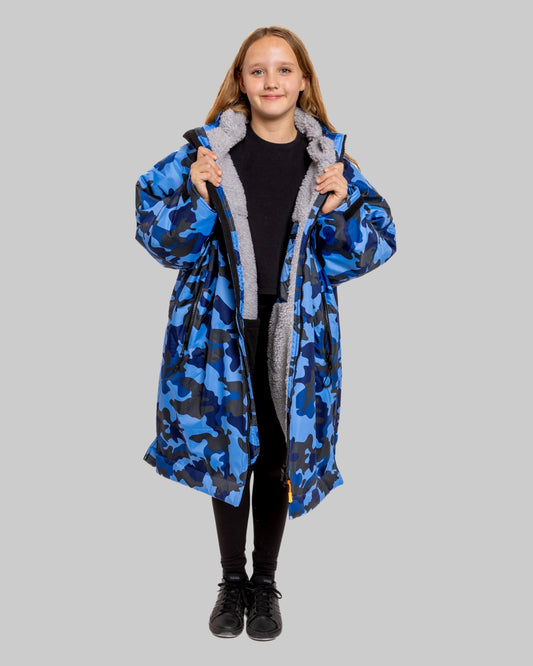 Model wearing RuggaRobe blue camo change robe with grey fleece interior on grey background