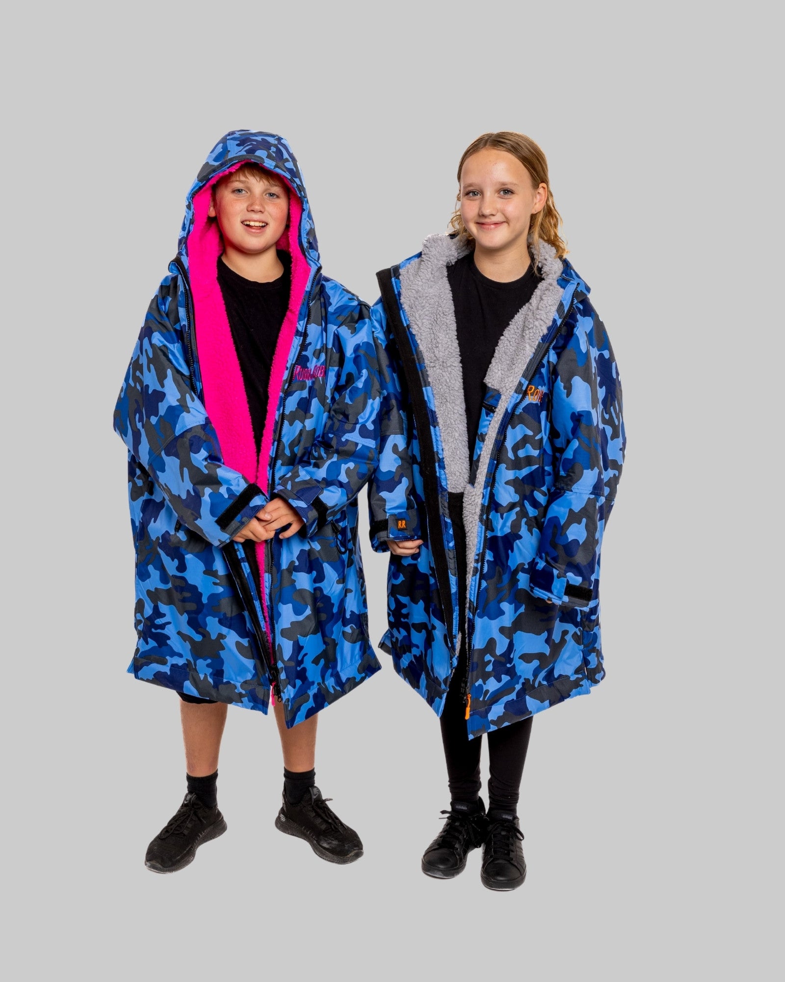 Model wearing RuggaRobe blue camo change robe with grey fleece interior on grey background