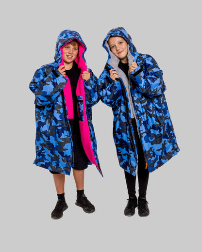Two childre wearing RuggaRobe blue camo change robe on grey background