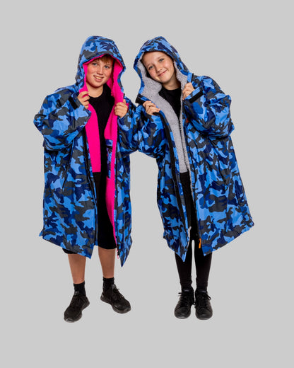 Model wearing RuggaRobe blue camo change robe with grey fleece interior on grey background