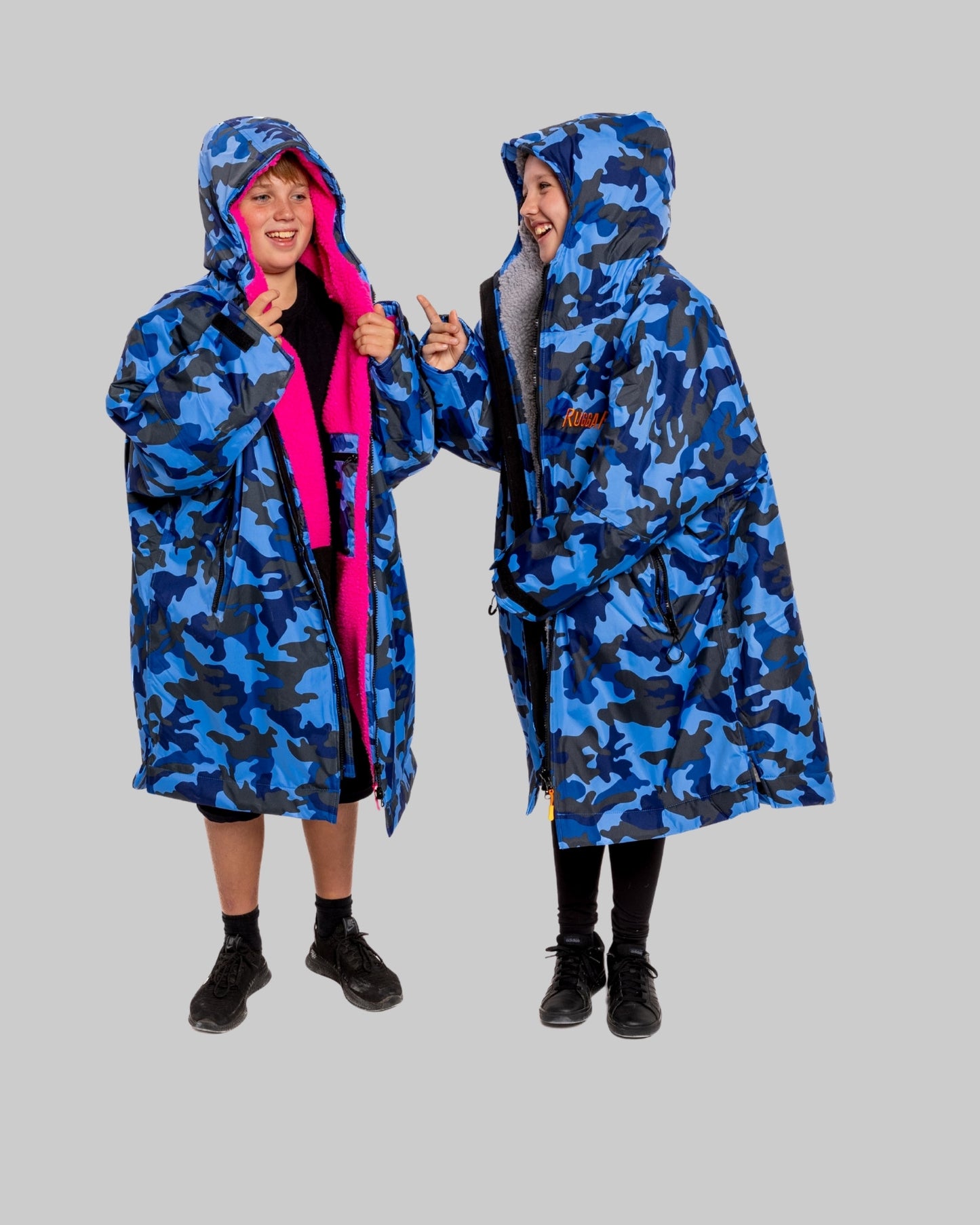 Model wearing RuggaRobe blue camo change robe with grey fleece interior on grey background