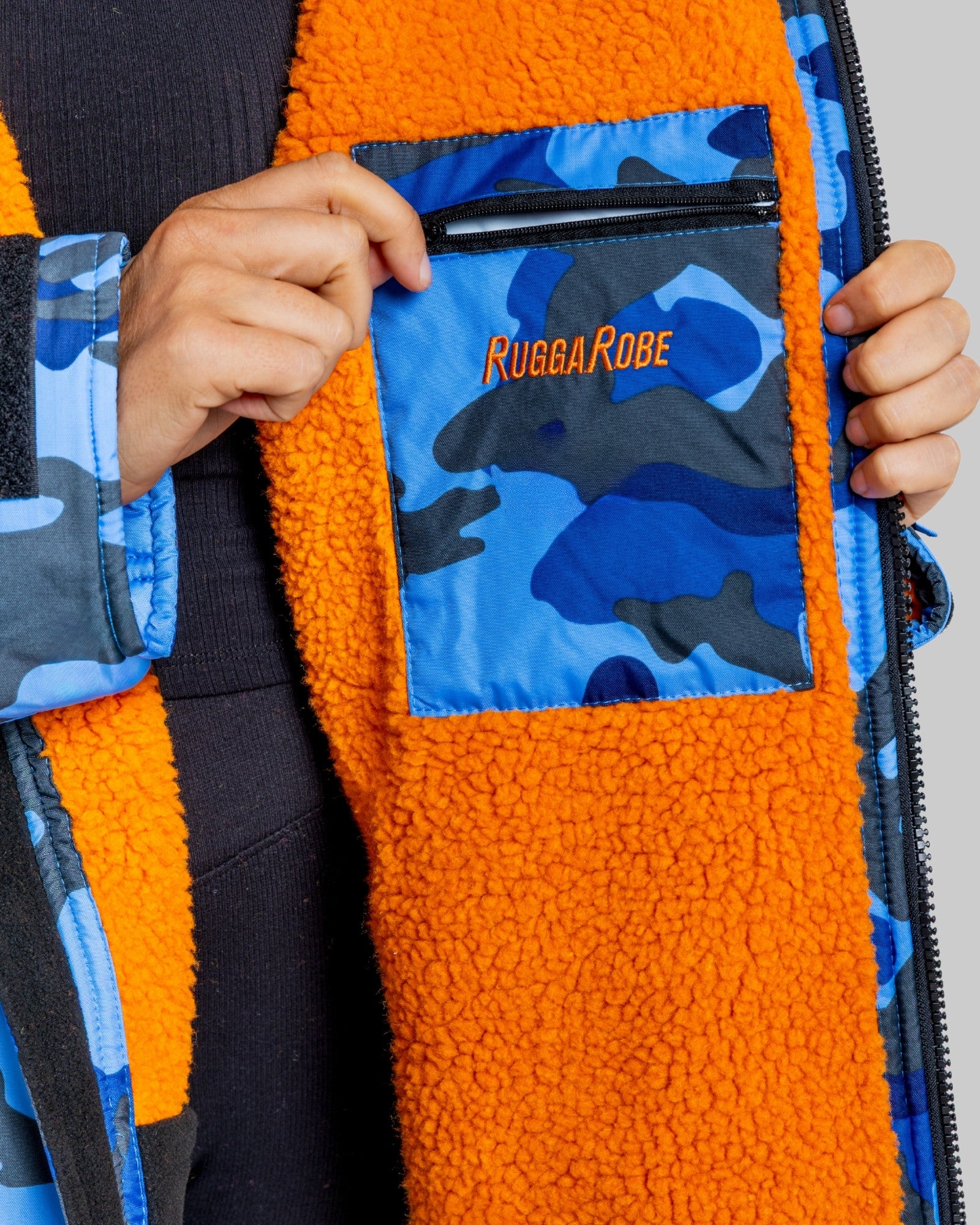 Orange fleece change robe with blue camouflage pattern and 'Rugga Robe' logo on a plain background