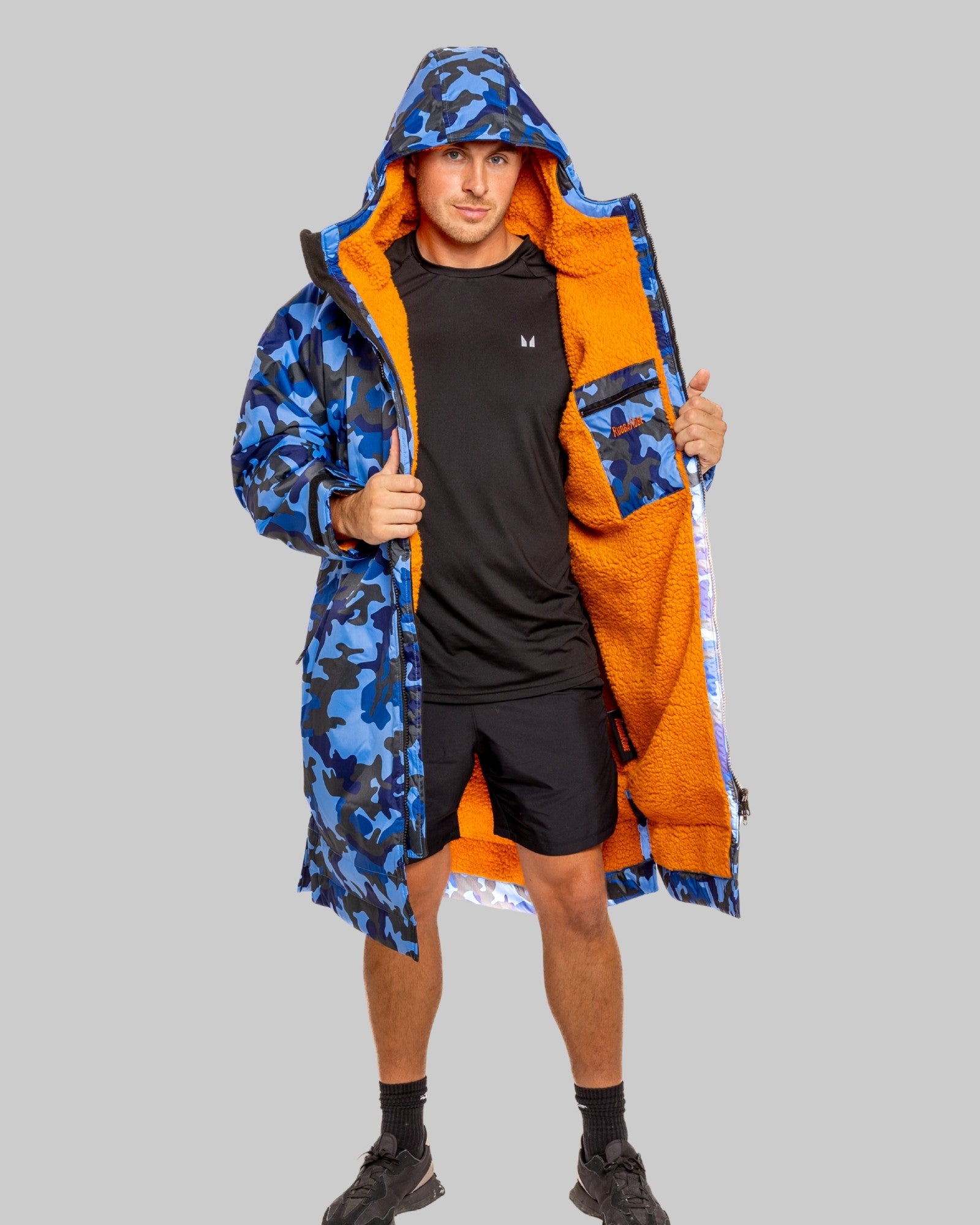Person wearing a blue and orange camouflage ruggarobe on a grey background