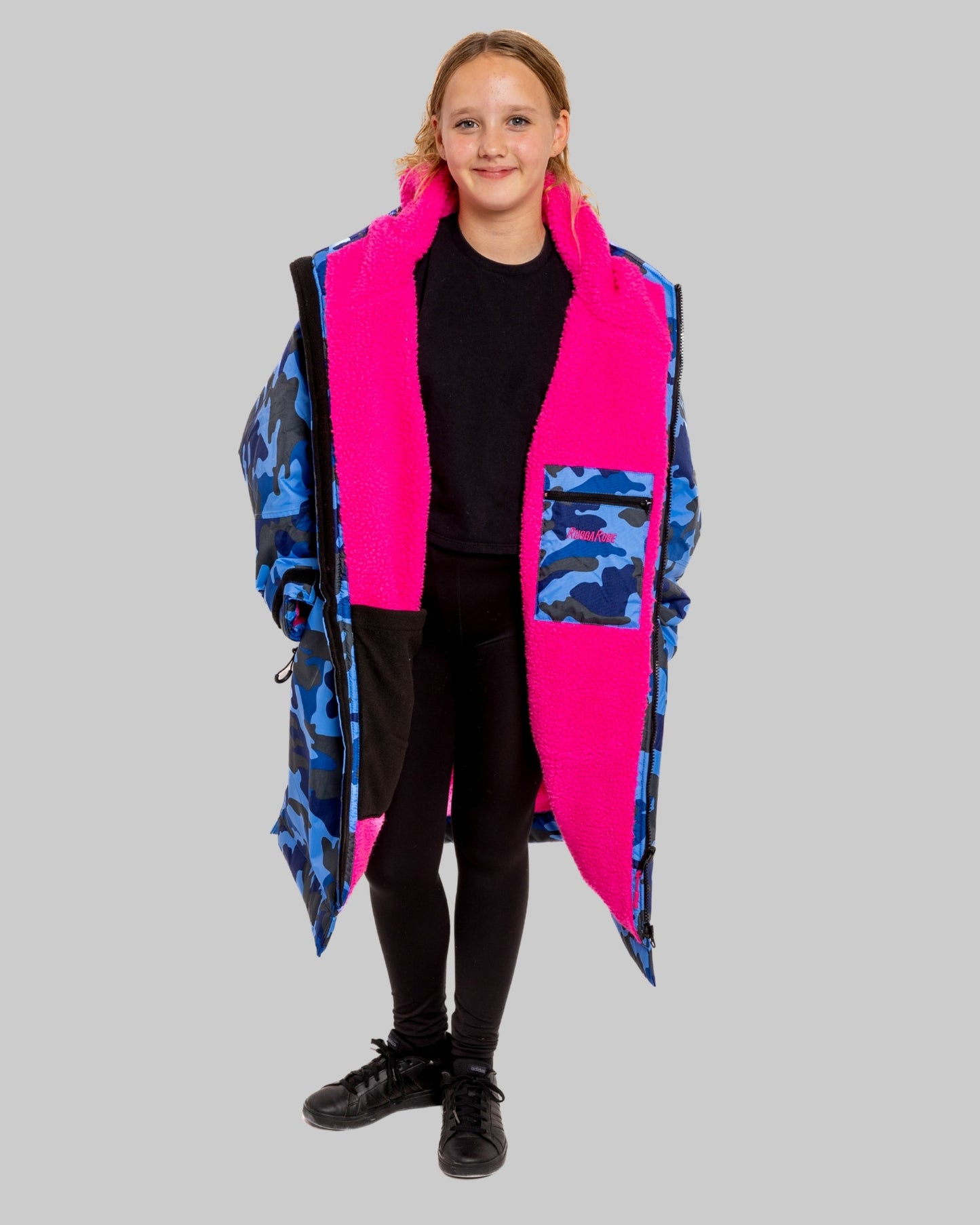 Model wearing RuggaRobe blue camo change robe with pink fleece interior on grey background