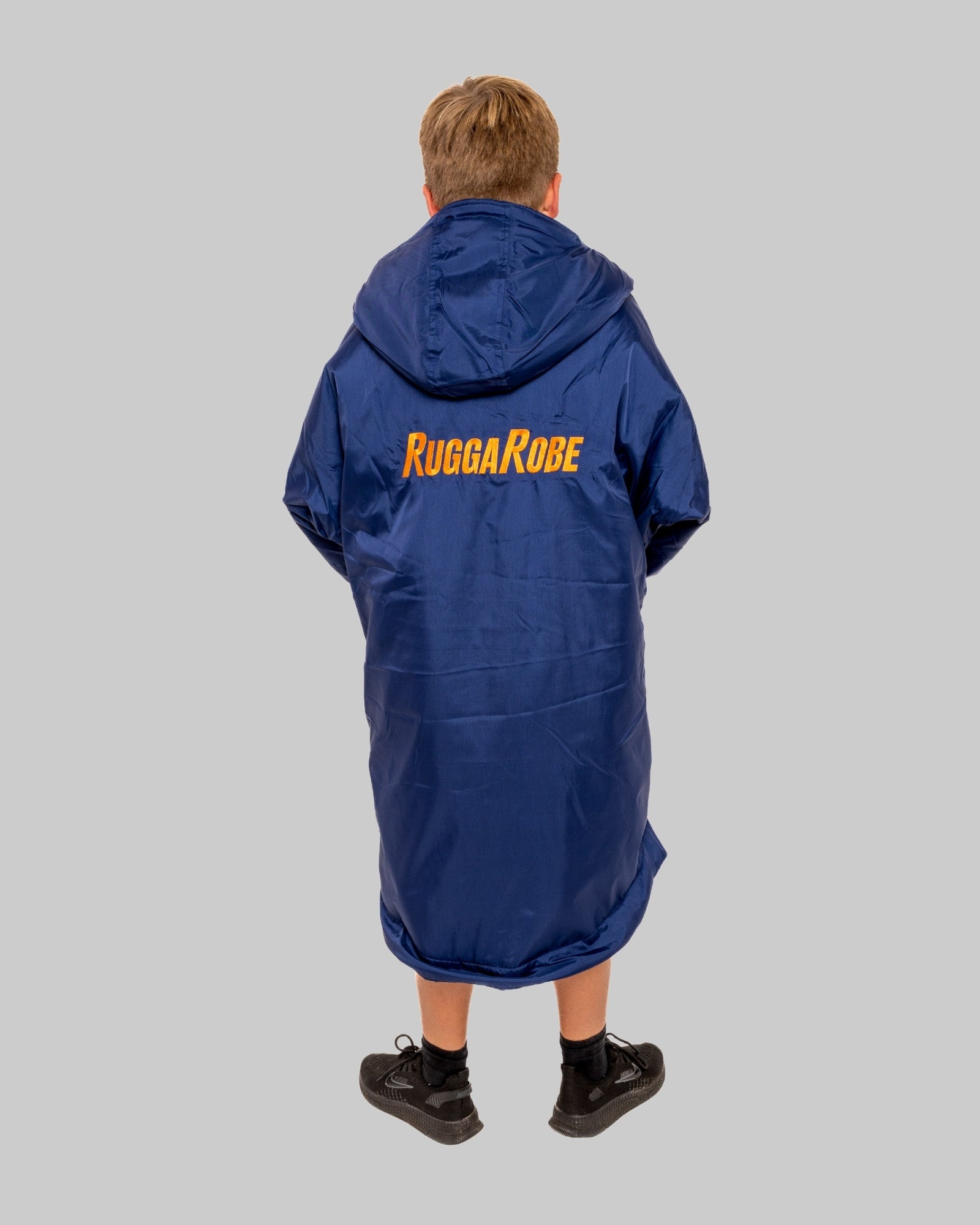 Person wearing a blue Rugga Robe with 'Rugga Robe' branding on the back against a gray background