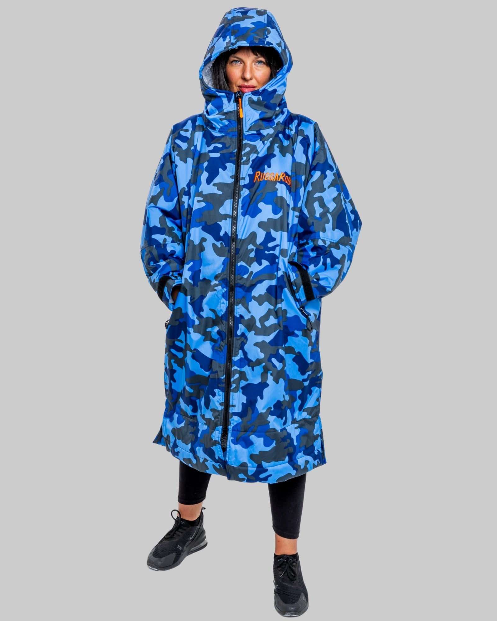 Person wearing a blue camo changerobe on a grey background