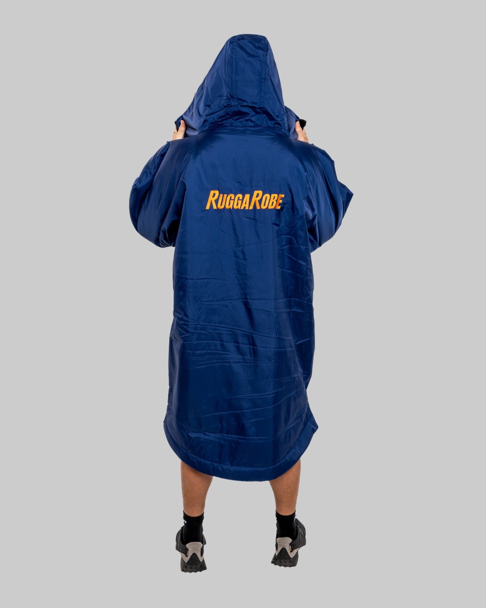Person wearing a blue Rugga Robe on a gray background